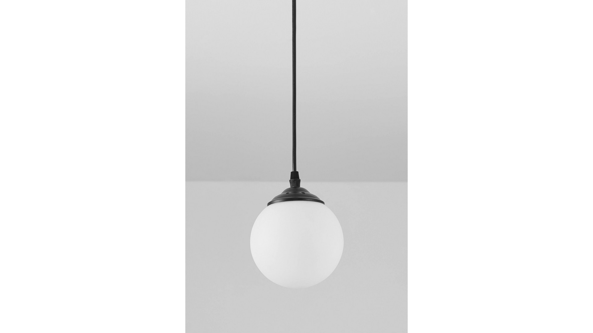 minimalistyczna lampa pojedyncza w kształcie białej kuli zawieszona na czarnej konstrukcji idealna do wnętrz w stylu modern